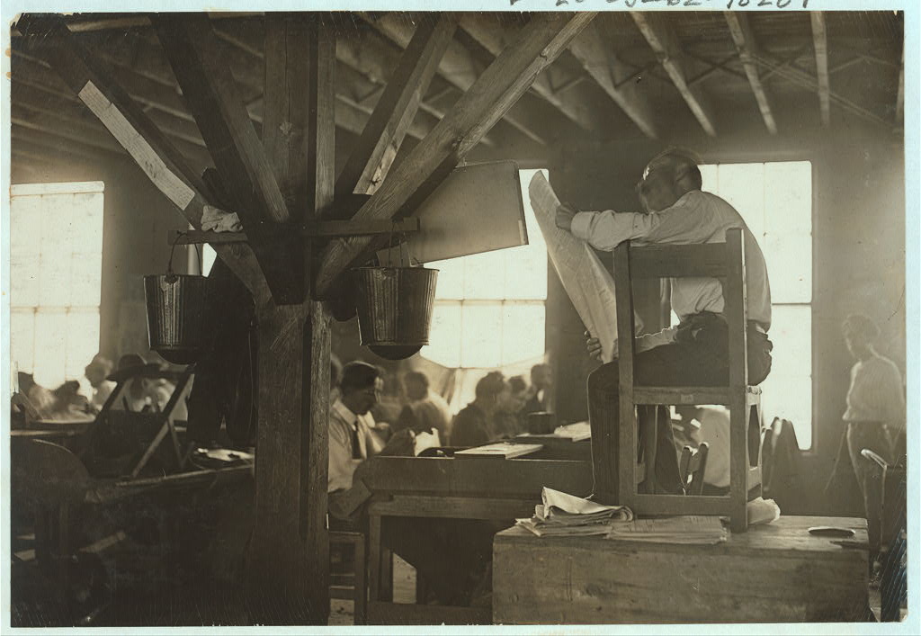 A lector reading to cigar workers in a Tampa cigar factory, 1909